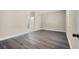 A calm, inviting bedroom with grey wood flooring and neutral-colored walls at 16519 Us Highway 41, Spring Hill, FL 34610