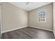 Bright bedroom features a ceiling fan, modern flooring, and a sunlit window at 16519 Us Highway 41, Spring Hill, FL 34610