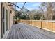 View of the spacious wooden deck featuring a light wood railing and access to the yard at 16519 Us Highway 41, Spring Hill, FL 34610