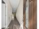 Inviting hallway features stylish dark floors and provides an open view to the light-filled living spaces beyond at 16519 Us Highway 41, Spring Hill, FL 34610