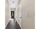 Neutral hallway features modern wood-look floors, recessed lighting, and access to various rooms throughout the home at 16519 Us Highway 41, Spring Hill, FL 34610