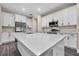 Modern kitchen boasts quartz countertops, stainless steel appliances, and white cabinets, creating a bright and functional space at 16519 Us Highway 41, Spring Hill, FL 34610
