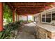 Charming back patio with stone flooring, a pergola, and an outdoor kitchen area at 2008 Berry Lake Dr, Brandon, FL 33510