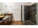 Bathroom features dual vessel sinks on granite counters, dark wood cabinets and tiled glass shower at 2008 Berry Lake Dr, Brandon, FL 33510