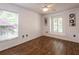 Bedroom with hardwood floors, ceiling fan and light coming in from the large windows at 2008 Berry Lake Dr, Brandon, FL 33510