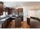 Updated kitchen with an island, granite counters and dark wood cabinets at 2008 Berry Lake Dr, Brandon, FL 33510