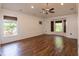Spacious living room with hardwood floors, ceiling fan and light coming in from large windows at 2008 Berry Lake Dr, Brandon, FL 33510