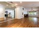 Spacious living room with wood floors, mirrored wall and plenty of natural light at 2008 Berry Lake Dr, Brandon, FL 33510