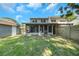 Backyard with a screened-in porch and a shed next to the house at 2048 Los Lomas Dr, Clearwater, FL 33763