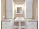 This bathroom features a bright and updated vanity, alongside abundant storage with white cabinets at 2048 Los Lomas Dr, Clearwater, FL 33763
