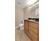 A functional bathroom presents a wood vanity, tile floor, and natural light for daily comfort at 2048 Los Lomas Dr, Clearwater, FL 33763