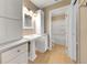 All-white bathroom offers an updated vanity and ample storage in a brightly lit space at 2048 Los Lomas Dr, Clearwater, FL 33763