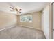 This spacious bedroom has neutral walls, a ceiling fan, and plush carpet, promoting rest and relaxation at 2048 Los Lomas Dr, Clearwater, FL 33763