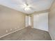Neutral bedroom includes a ceiling fan, plush carpet, and sliding closet for maximized storage at 2048 Los Lomas Dr, Clearwater, FL 33763
