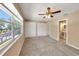 Enjoy this sizable bedroom featuring a large window, fan, and plentiful closet space at 2048 Los Lomas Dr, Clearwater, FL 33763