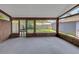 Spacious enclosed porch with wood trim and views of the fenced backyard at 2048 Los Lomas Dr, Clearwater, FL 33763