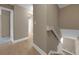 Hallway with hardwood flooring, neutral paint, and views into other rooms of the home at 2048 Los Lomas Dr, Clearwater, FL 33763