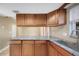 Kitchen featuring granite countertops, oak cabinetry, and a breakfast bar at 2048 Los Lomas Dr, Clearwater, FL 33763