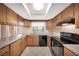 Bright kitchen featuring tile floors, granite counters, and modern appliances at 2048 Los Lomas Dr, Clearwater, FL 33763