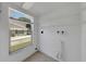 Bright laundry room with window and exterior view, tile flooring and built-in shelving at 2048 Los Lomas Dr, Clearwater, FL 33763