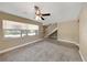 Living room with carpet, fan, and staircase at 2048 Los Lomas Dr, Clearwater, FL 33763