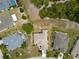 Overhead shot of a home surrounded by well-manicured lawns and natural green spaces at 2258 Preservation Green Ct, Sun City Center, FL 33573