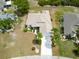 Bird's eye view of a well-maintained home with lush landscaping and a spacious driveway at 2258 Preservation Green Ct, Sun City Center, FL 33573