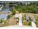 A sunny view of the property with manicured lawns and tropical palms create an inviting exterior at 2258 Preservation Green Ct, Sun City Center, FL 33573