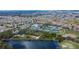 Expansive aerial view showcasing the community's baseball field, tennis courts, pond, and residential area at 2258 Preservation Green Ct, Sun City Center, FL 33573