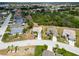 Scenic aerial shot displays the front of the home nestled amid verdant lawns and tropical palms in a community setting at 2258 Preservation Green Ct, Sun City Center, FL 33573