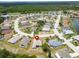 Aerial view of homes in a quiet neighborhood with lush landscaping and water features nearby at 2258 Preservation Green Ct, Sun City Center, FL 33573