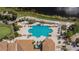 Aerial view showcasing the community pool and lounge area surrounded by manicured landscaping and palm trees at 2258 Preservation Green Ct, Sun City Center, FL 33573