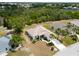 Lush landscaping with tropical plants and manicured lawns frame this home's appealing exterior at 2258 Preservation Green Ct, Sun City Center, FL 33573