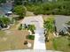 The front of the house is framed by tropical palms and mature landscaping, providing great curb appeal at 2258 Preservation Green Ct, Sun City Center, FL 33573