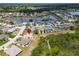 An aerial view showcases the property's location in a scenic neighborhood with a lake and verdant surroundings at 2258 Preservation Green Ct, Sun City Center, FL 33573