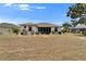 Screened in lanai featuring views of a backyard with lush and mature landscaping at 2258 Preservation Green Ct, Sun City Center, FL 33573