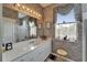 Bathroom with a large vanity, decorative wallpaper, and a window, providing plenty of natural light at 2258 Preservation Green Ct, Sun City Center, FL 33573