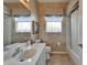 Bathroom featuring a vanity with sink, decorative wallpaper, and bathtub with shower curtain at 2258 Preservation Green Ct, Sun City Center, FL 33573