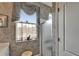Bathroom with wallpaper, glass shower door, and decorative window at 2258 Preservation Green Ct, Sun City Center, FL 33573