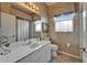 Well-lit bathroom featuring a vanity with a sink, decorative wallpaper, and a window at 2258 Preservation Green Ct, Sun City Center, FL 33573