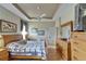 This bedroom features hardwood floors, a ceiling fan, and a large dresser at 2258 Preservation Green Ct, Sun City Center, FL 33573