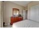Bedroom featuring a large dresser with mirror and neutral décor, providing ample storage at 2258 Preservation Green Ct, Sun City Center, FL 33573