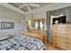 This bedroom features hardwood floors, a ceiling fan, and a large dresser at 2258 Preservation Green Ct, Sun City Center, FL 33573