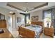 This bedroom features hardwood floors, a ceiling fan, and decor above the doorway at 2258 Preservation Green Ct, Sun City Center, FL 33573