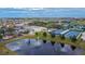 Aerial view of community center near pond, golf course and tennis courts at 2258 Preservation Green Ct, Sun City Center, FL 33573
