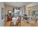 Charming dining area boasts hardwood floors, chandelier, and ample natural light at 2258 Preservation Green Ct, Sun City Center, FL 33573