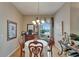 Bright dining room featuring hardwood floors, large window, and classic decor at 2258 Preservation Green Ct, Sun City Center, FL 33573