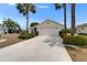 Well-maintained home featuring a two-car garage, manicured lawn, and mature landscaping at 2258 Preservation Green Ct, Sun City Center, FL 33573