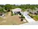 Attractive home showcasing a manicured lawn, mature palm trees, and a convenient two-car garage at 2258 Preservation Green Ct, Sun City Center, FL 33573