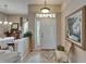 Inviting foyer with a decorative tile inlay, elegant lighting, and a glimpse of the dining area at 2258 Preservation Green Ct, Sun City Center, FL 33573